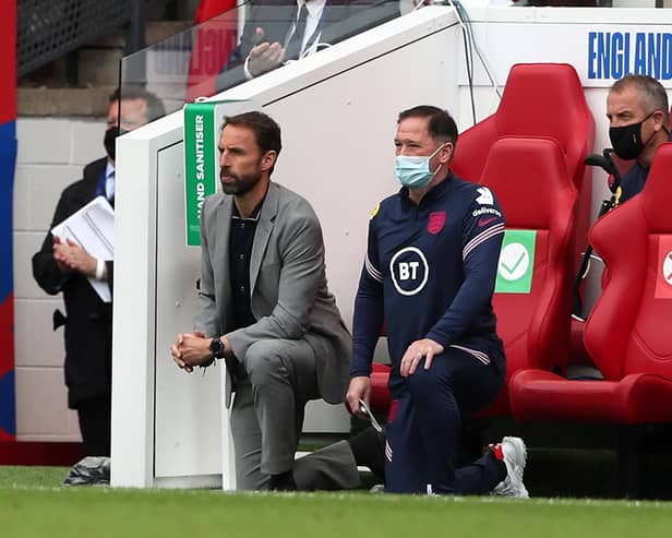 England's manager Gareth Southgate (L) and Steve Holland, Assistant Coach of England (R) 'take a knee' ahead of the international friendly football match between England and Romania at the Riverside Stadium in Middlesbrough.
