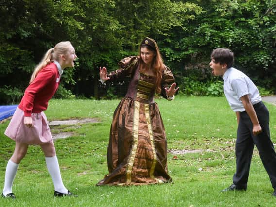 Pupils from Hambleton Primary take part in Shakespeare Day by shouting insults in the style of the Bard. Year 6 pupils Ellie Pangburn and Ashton Wright with director of English Estelle Bellamy. Photos by Dan Martino