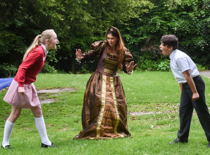 Pupils from Hambleton Primary take part in Shakespeare Day by shouting insults in the style of the Bard. Year 6 pupils Ellie Pangburn and Ashton Wright with director of English Estelle Bellamy. Photos by Dan Martino