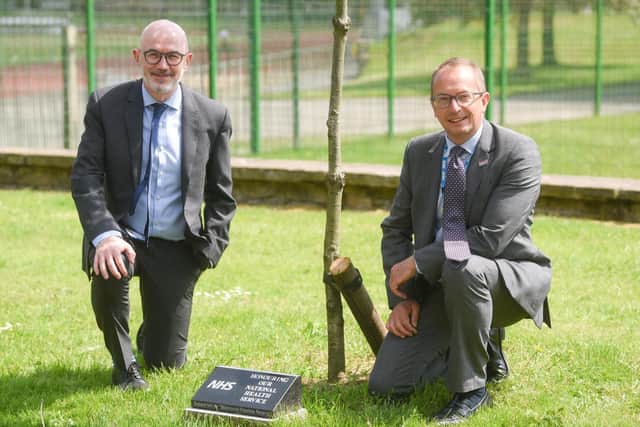 Peter Murphy and Jim Gardner from Blackpool Teaching Hospitals with the tree dedicated to the NHS.