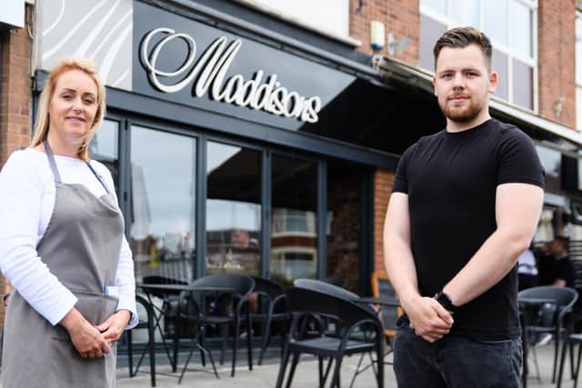 Cobi Barber, 22, pictured with mum Lisa who co-owns Maddisons cafe bar, saved a customer's life this week when he performed a Heimlich manoeuvre while she was choking. Picture: Kelvin Stuttard/JPI Media