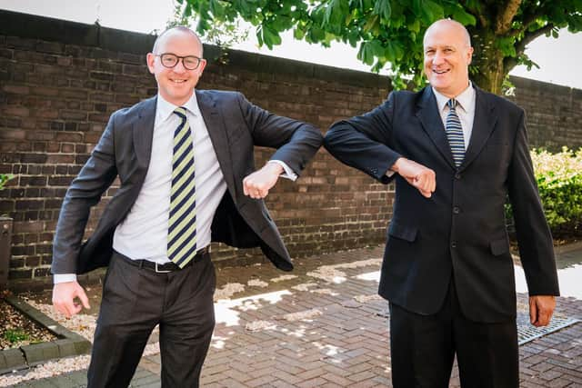 Andy Pratt (right) is congratulated on his MBE award by Lancashire Police and Crime Commissioner Andrew Snowden