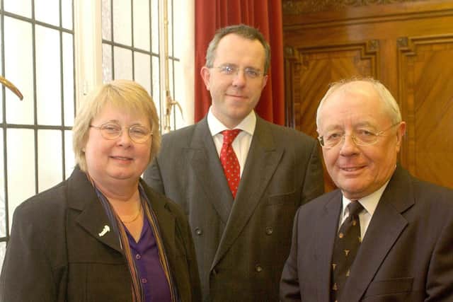 Howard McCann, right, pictured on his retirement in 2004, with County Councillor
Doreen Pollitt, and Dr James Adeley who took over as coroner