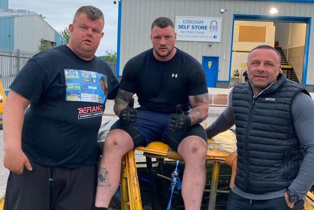 Bill Hodgson (centre) completed a 24-hour charity tyre-flip with the support of friends like Ryan Smith (left)