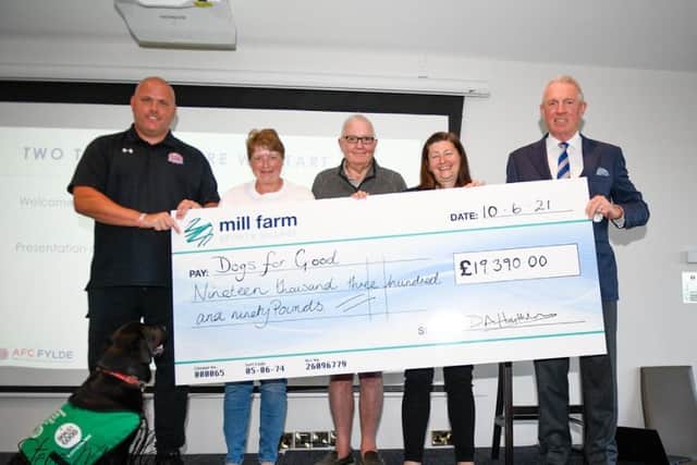AFC Fylde manager Jim Bentley (left) and owner David Haythornthwaite (right) make the presentation to Dogs For Good