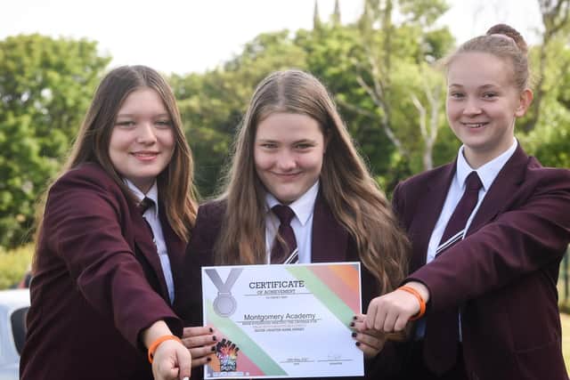 Taleea Jessop, Caitlin Colledge and Abbie Walsh with Montgomery Academy's silver charter mark award for anti-bullying. Picture: Dan Martino/JPI Media