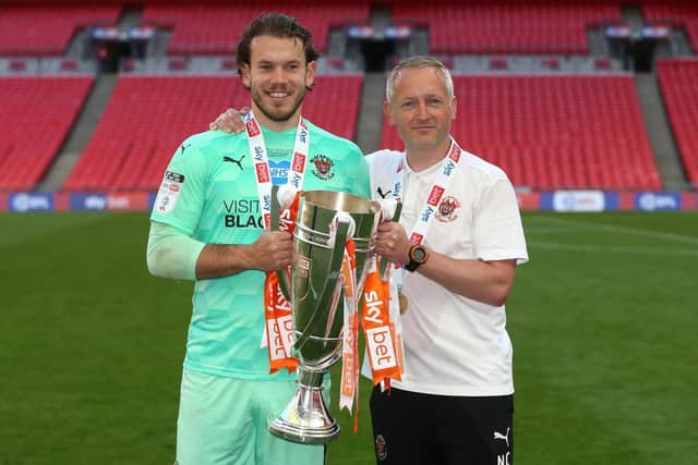 Neil Critchley and Chris Maxwell celebrate Blackpool's promotion
