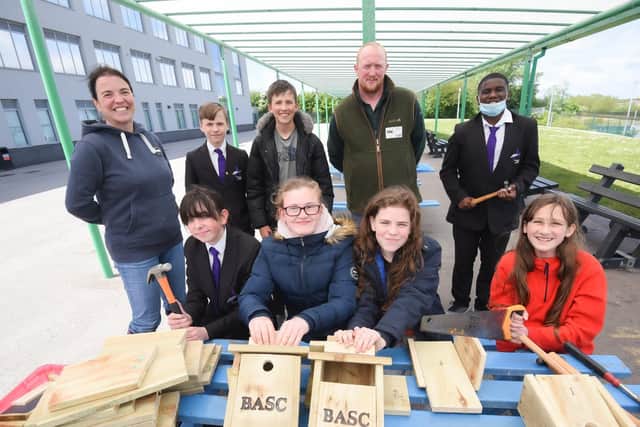 Teacher Peggy Plancke with Murray Woodward from BASC, helping year eight pupils from Aspire Academy to build bird boxes. Picture: Daniel Martino/JPI Media