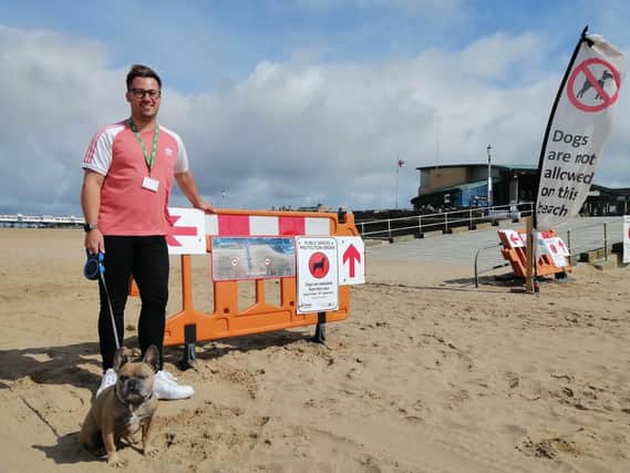 Coun Michael Sayward with his dog Ralph at the new signage and barriers marking out the dog exclusion zone on St Annes beach