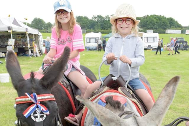 Paloma and Pippa Smith ride the donkeys at the Fylde Vintage and Farm Show 2019