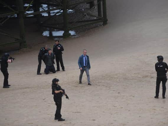Taking centre stage on the beach near Central Pier was actor James Nesbitt, in the role ofa homicide detective, as 'armed police' surroundeda suspect with their guns drawn