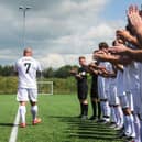 Jordan Banks' step-dad Daniel and dad Matt are applauded onto the pitch during a charity match in the youngster's memory. Photo: Daniel Martino/JPI Media