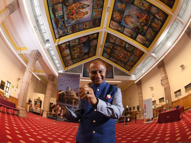 Ishwer Tailor pictured inside the temple with the new guidebook Photo: Neil Cross