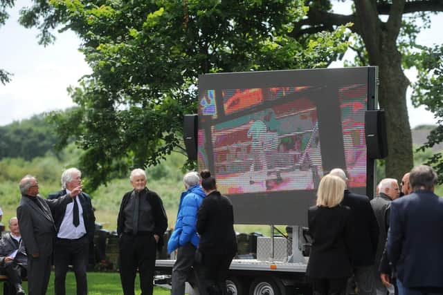 A projector outside the crematorium played clips of Brian in his boxing days