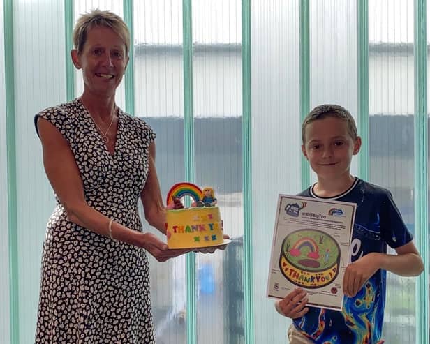 Deputy chief executive Nicki Latham with Thomas Ryan and his birthday cake design. Pic: Blue Skies