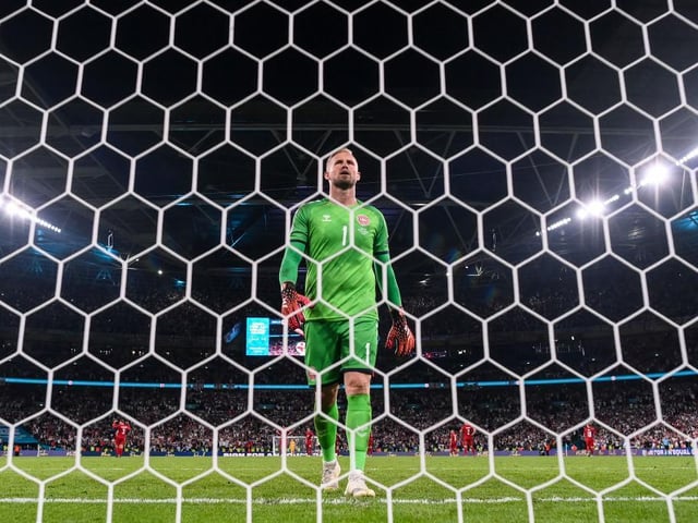 Kasper Schmeichel of Denmark looks dejected after conceding their side's second goal scored by Harry Kane