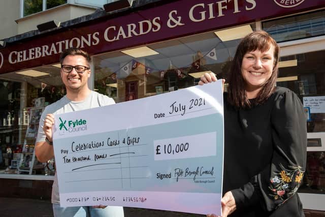 Sarah Mangan of Celebrations Cards and Gifts is presented with the grant money by Coun Michael Sayward outside the Lytham shop