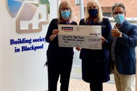 Neil Reid of Blackpool Food Bank receives the cheque from Nationwide representatives