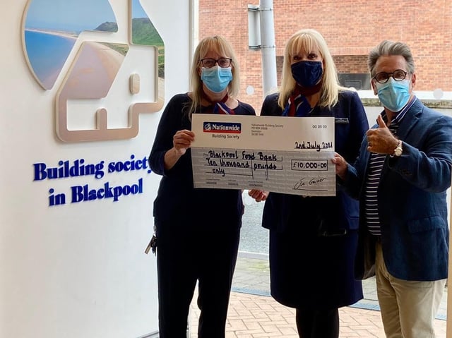 Neil Reid of Blackpool Food Bank receives the cheque from Nationwide representatives