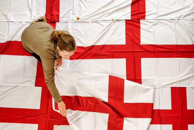A member of staff preparing one of the specially designed St George's flags