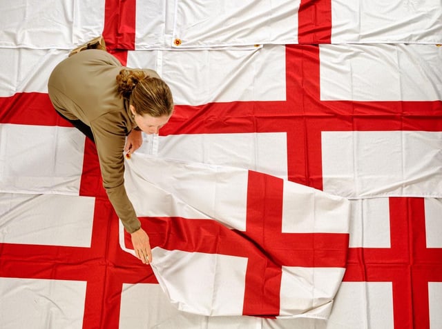 A member of staff preparing one of the specially designed St George's flags
