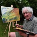 Michael Hipkins pictured at work on a painting  Photo: Neil Cross