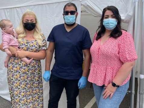 Charlie (left) and Amanda Cheese (right) dropped into the Vaccine Van at Blackpool Central Mosque with baby Matilda. They received vaccine 1,000 and 1,001 administered by the van.