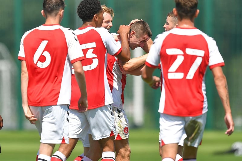 Fleetwood players congratulate Jordan Rossiter for opening the scoring.