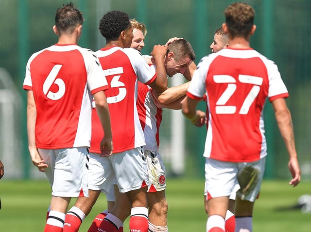 Fleetwood players congratulate Jordan Rossiter for opening the scoring.