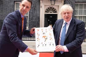 Chris Hull presents the Morty celebration artwork to Prime Minister Boris Johnson outside No 10 Downing Street.