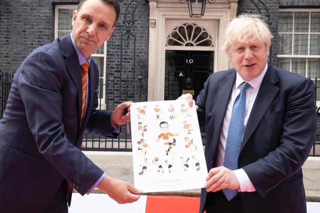 Chris Hull presents the Morty celebration artwork to Prime Minister Boris Johnson outside No 10 Downing Street.