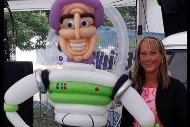 Joanne with the Toy Story Buzz Lightyear character she made from balloons