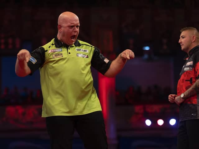 Michael van Gerwen meets Peter Wright after defeating Nathan Aspinall last night Picture: Lawrence Lustig/PDC
