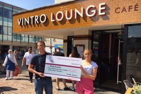 Vintro's general manager Martyn Reid hands over a cheque for 1,418 to Trinity Hospice and Brian House. Photo: Vintro Lounge