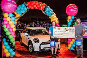 Coral Island's head of marketing John Chamley presents a cheque to Blue Skies
community fundraiser Joanna Allitt, after raising a total of £6,500 by selling face masks. Pic: Blue Skies Hospitals Fund