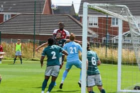 Darnell Johnson climbs highest for a corner but Fleetwood could not breach the Wrexham defence