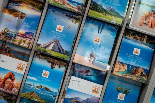 Travel brochures are on display in a travel agency