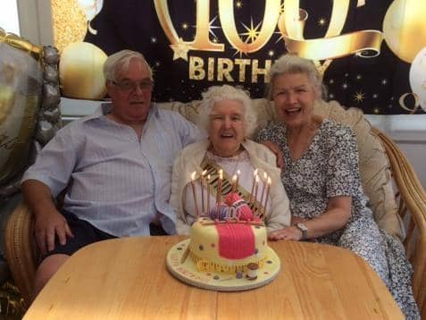 Hilda Smart with son George and daughter Hilary, and a knitting themed birthday cake