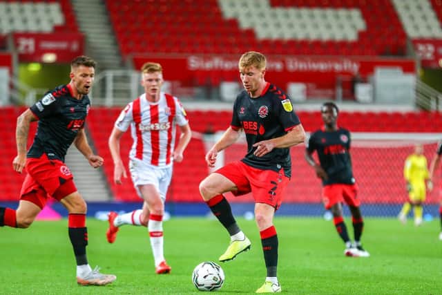 Fleetwood newcomer Brad Halliday, here on the ball at Stoke, hasn't missed a minute of the action so far this season