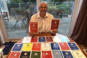 Roger Holmes with his football club history booklets
