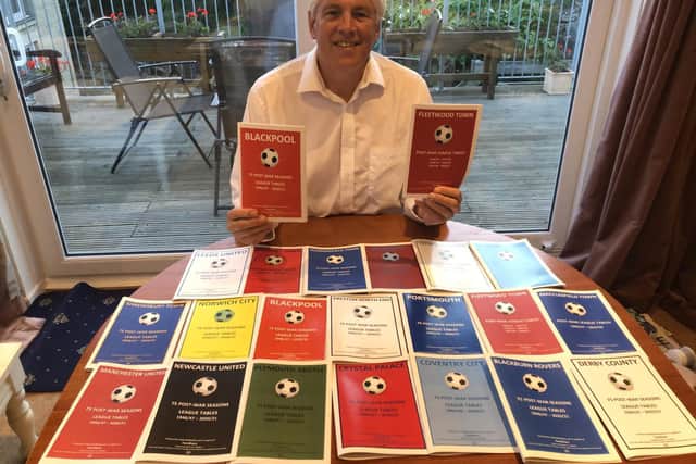 Roger Holmes with his football club history booklets