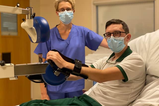 Occupational therapist Tom Glithero demonstrates the device, funded by Blue Skies, with Nicky Williams. Pic: Blue Skies Hospitals Fund