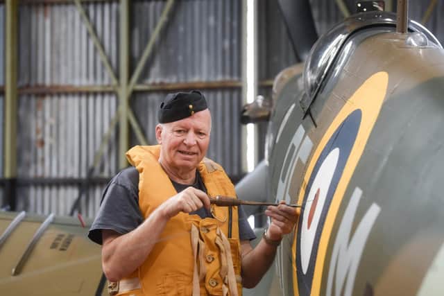 Volunteer Paul Lomax takes a close look at the aircraft.