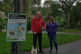 Coun Roger Small at one of the new signs in Ashton Gardens, St Annes with resident Alison Allen, who recently found and reported an injured swan
