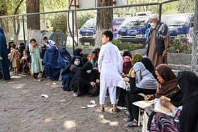 Internally displaced Afghan families, who fled from Kunduz and Takhar province due to battles between Taliban and Afghan security forces, eat their lunch at the Shahr-e-Naw Park in Kabul on 10th August, 2021