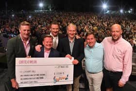 The money was presented to the Hall by Cuffe and Taylor on stage at the Russell Watson concert