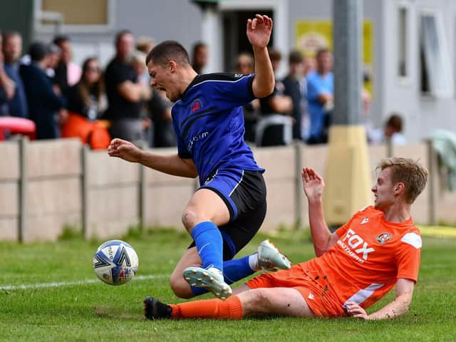 Kyle White makes a strong challenge for Blackpool against Garstang