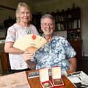 Brian Dickinson and wife Val with Paralympic medals and other mementoes from the Tokyo Games of 1964