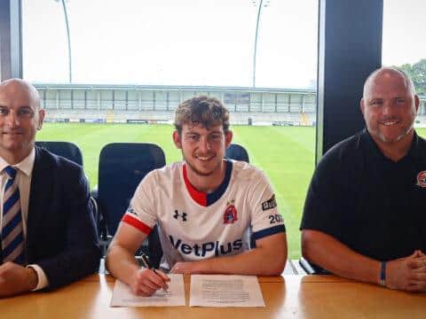 Dan Pike signs for AFC Fylde flanked by chief executive Jonty Castle (left) and team boss Jim Bentley