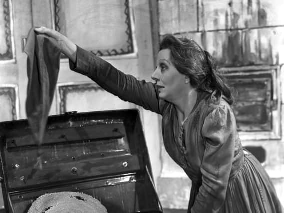 Dame Edith Evans searches through an old tin trunk in a scene from ‘Crime and Punishment’ at the New Theatre, 1946. Pic: Getty Images